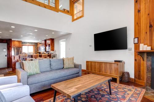 a living room with a couch and a tv at SNOW FLOWER 029 condo in Park City