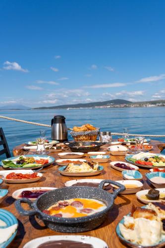 a table full of food on top of the water at CasaLyma Ayvalık in Ayvalık