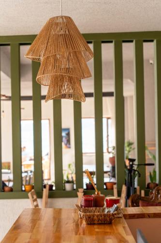 a pendant light hanging over a wooden table at CasaLyma Ayvalık in Ayvalık