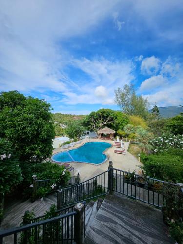 a view of a swimming pool from a balcony at Phangan Utopia Resort in Mae Haad