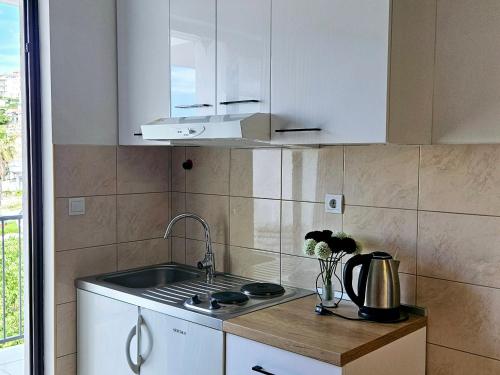 a kitchen with a sink and a counter top at Apartments Casablanca in Podstrana