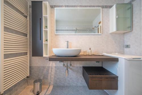 a bathroom with a sink and a mirror at Le Nid Charmant Cir n. 132 in Aosta