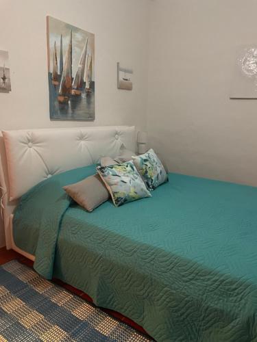 a bed with two pillows on it in a room at Casa ridente in Arzachena