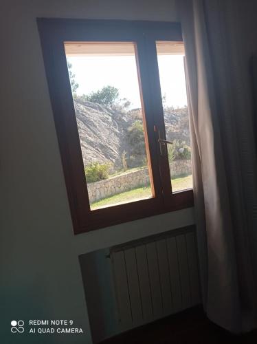 two windows in a room with a door at Casa ridente in Arzachena