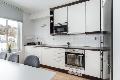 a kitchen with white cabinets and a counter top at KungsbergetNatur in Järbo