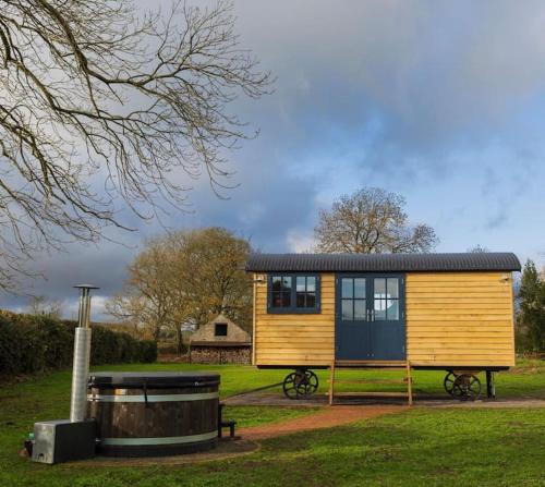 a tiny house on display in a field at Toadland Shepherd Huts in Durham