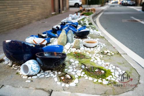 a row of blue bowls on the side of a street at Sea 3 min away - Free Park - Trains 8 min - Air Conditioner in Albisola Superiore