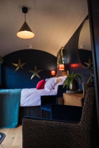 a bedroom with a bed with stars on the wall at Toadland Shepherd Huts in Durham