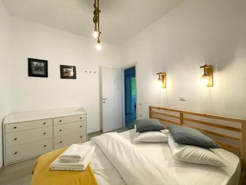 a bedroom with two beds and a dresser at Cozy Riverfront Apartments with garden and mountain view in Buşteni