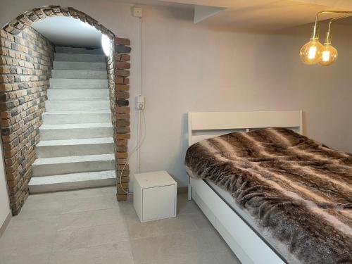 a bedroom with a bed and a staircase at New flat in Limhamn in Limhamn