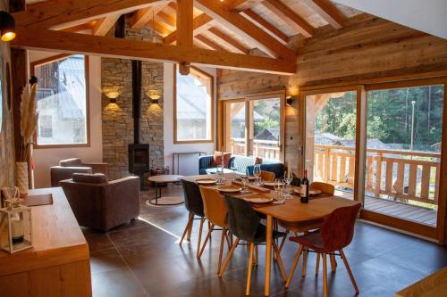 a wooden dining room with a table and chairs at Chalet Holtanna in Montriond