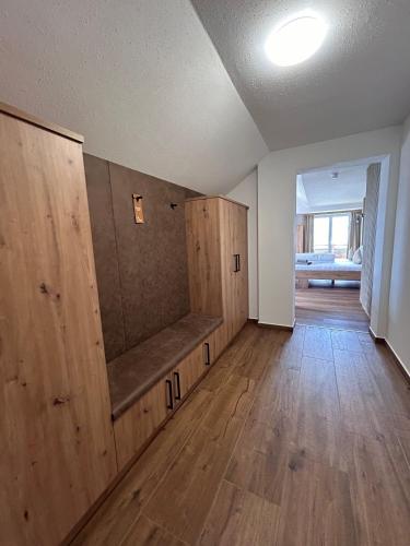 an empty room with wooden cabinets in a house at Gasthof Steinbichler in Nussdorf am Attersee