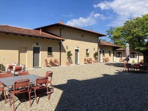 a table and chairs in front of a building at La Corte Nascosta Volpedo in Volpedo