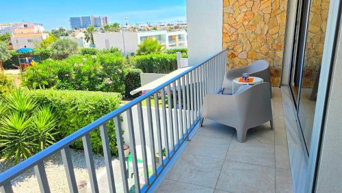 a blue railing on a balcony with a chair at Segolene Design in Albufeira