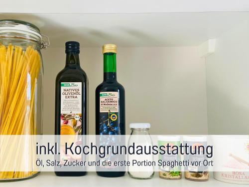 two bottles of wine sitting on a shelf at Schöne, ruhige Stadtwohnung, Küche, SmartTV, 1-5 Pers in Brandenburg an der Havel