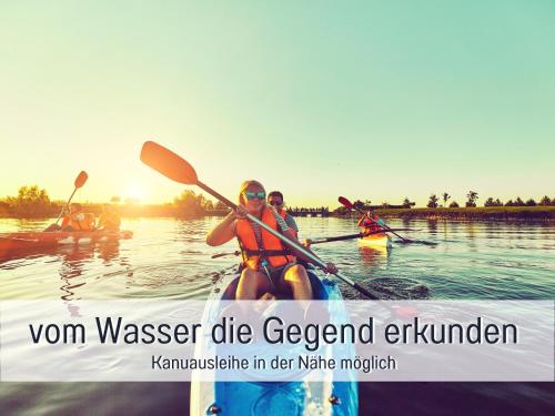 a group of people in kayaks on the water at Schöne, ruhige Stadtwohnung, Küche, SmartTV, 1-5 Pers in Brandenburg an der Havel