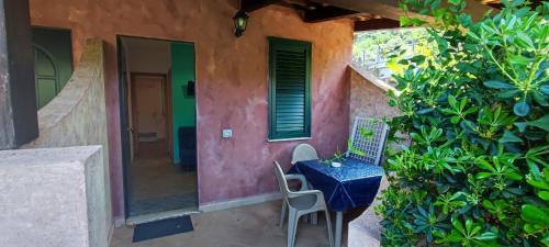 a table and chairs on a porch of a house at Residenza La Vigna in Parghelia