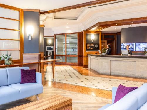 a lobby with a bar with purple pillows at Novotel Bristol Centre in Bristol