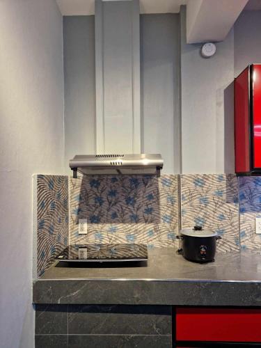a kitchen with a counter top with a stove at S & R Homes in Tacloban