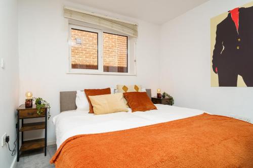 1 dormitorio con 1 cama grande con manta naranja en Central Location, Sleeps 3, Perfect for Trades, en Hemel Hempstead