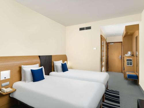 Postel nebo postele na pokoji v ubytování Novotel Budapest Danube