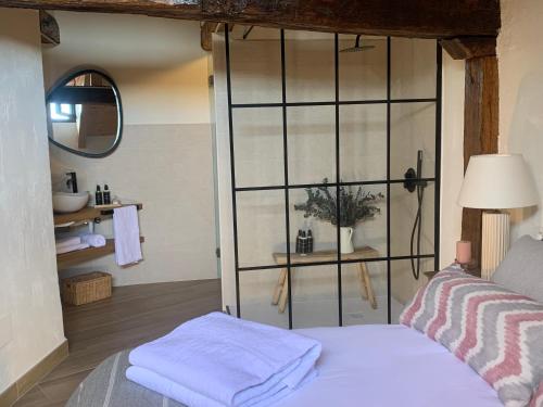 a room with a bed and a glass wall at HOTEL RURAL SANTUI in Horcajuelo de la Sierra