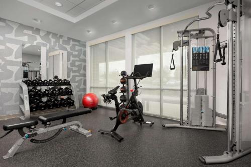 a fitness room with a gym with a treadmill and weights at Home2 Suites by Hilton Knoxville West in Knoxville
