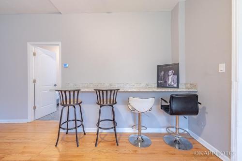 a kitchen with two bar stools and a counter at Wonderful Home Close to Downtown Chicago - Free Parking in Chicago