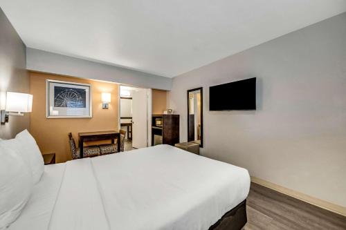 a hotel room with a large bed and a television at Comfort Inn Beach Boardwalk in Santa Cruz