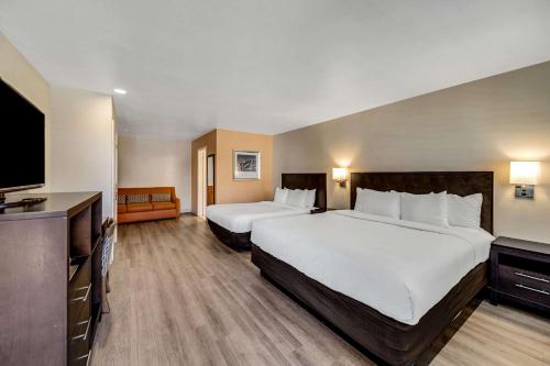 a hotel room with two beds and a flat screen tv at Comfort Inn Beach Boardwalk in Santa Cruz