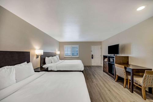 a hotel room with a large bed and a desk at Comfort Inn Beach Boardwalk in Santa Cruz
