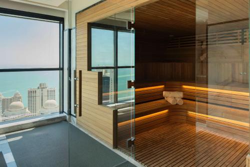 a sauna in a building with a view of the city at Waldorf Astoria Doha West Bay in Doha