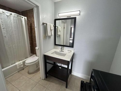 a bathroom with a sink and a toilet and a mirror at Motel 6 Hammond, LA – I 12 – I 55 in Hammond