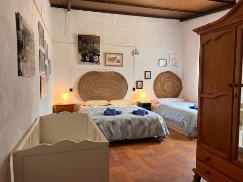 a bedroom with two beds in a room at Casa Rural Quejigo con piscina in Santa Olalla del Cala