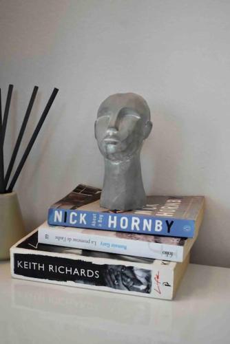 a statue sitting on top of three books at Bubbles Penthouse with Jacuzzi in Podstrana