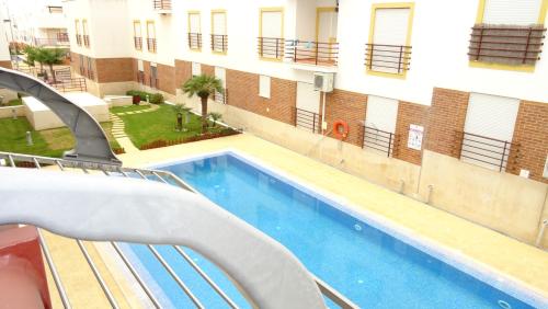 a view of a swimming pool next to a building at Quinta Gomeira by Amandio Batista in Cabanas de Tavira