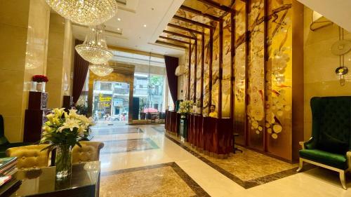 a lobby of a hotel with a vase of flowers at Golden Silk Boutique Hotel in Hanoi