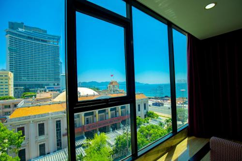 a view of a city from a room with windows at Happy Light Central Nha Trang in Nha Trang