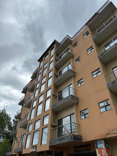 a tall building with windows and balconies on it at Shaiz Apartments Bhurban, Murree in Murree