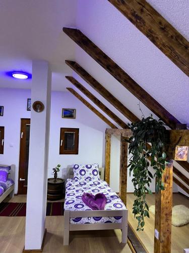 a living room with a bed in a room at NINA Apartmani in Plav