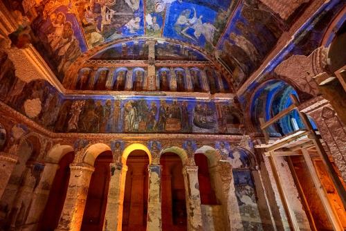 a room with a ceiling with paintings on it at Very Peri Cappadocia - The Lifestyle Luxury Design Hotel in Uchisar