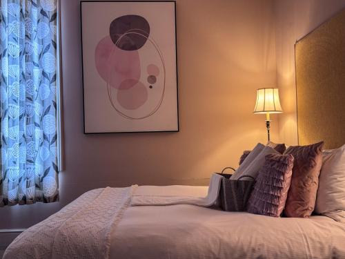 a bedroom with a bed with a picture on the wall at The Chatwal Boutique Hotel in Blackpool