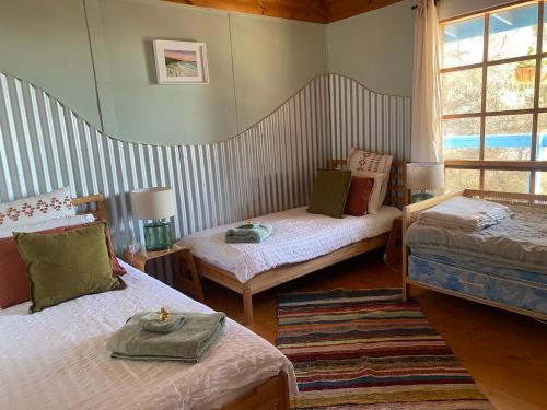 a room with two beds and a window at Sheoak Lodge in Penneshaw