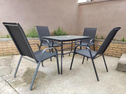 a table and four chairs sitting next to a building at Ticina apartment in Sarajevo