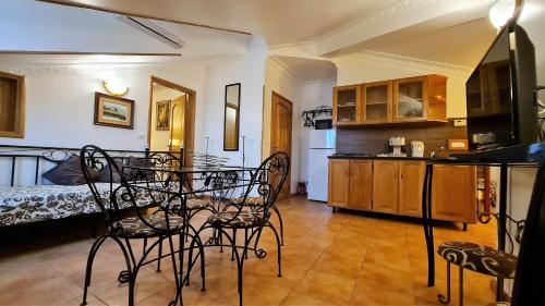 a kitchen with chairs and a table in a room at Silver Village Residence in Maceira