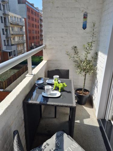 a small table on a balcony with a toy on it at Modern appartement met uniek zeezicht in Koksijde