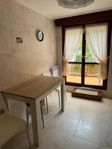 a dining room with a table and a window at Unquera (mar y montaña) in Unquera