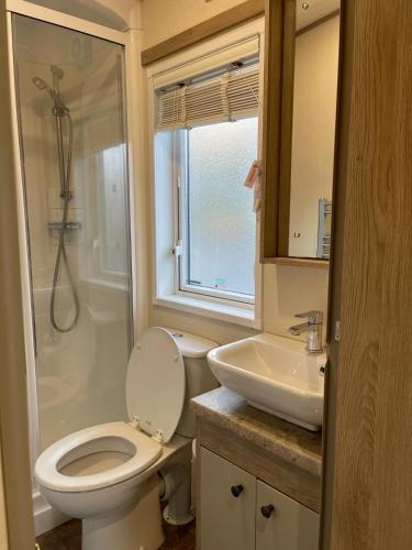 a bathroom with a toilet and a sink at Shangri la at Beauport in Westfield