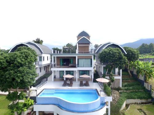 an aerial view of a house with a swimming pool at Buraphat Resort in Chiang Dao