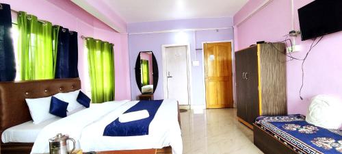 a bedroom with purple and green curtains and a bed at Hotel Orchid in Kalimpong